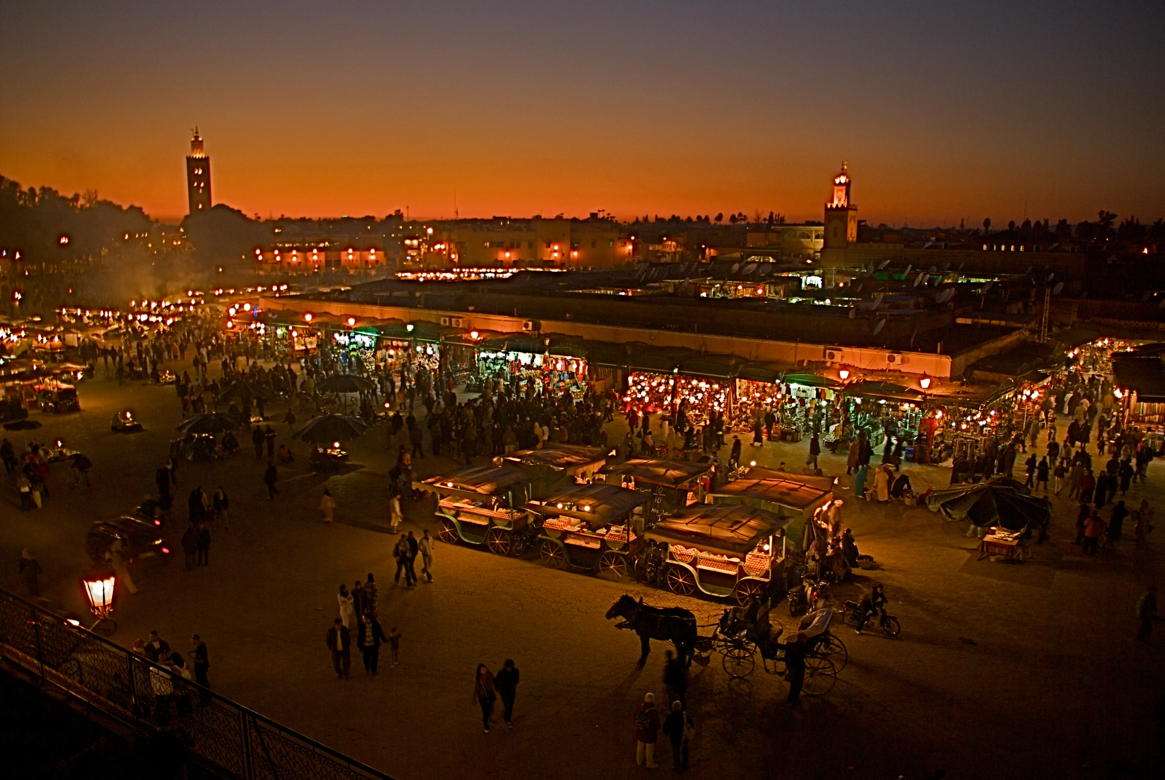 Jemaa el-Fna square lit up in the evening, buzzing after breaking the fast during Ramadan